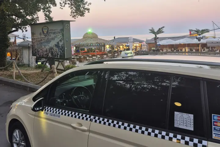 Taxi beside a seaside restaurant in Golden Sands at dusk